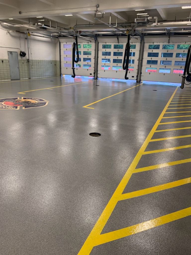 Fire station grey decorative quartz floor with lines and logo, Elmsford, NY