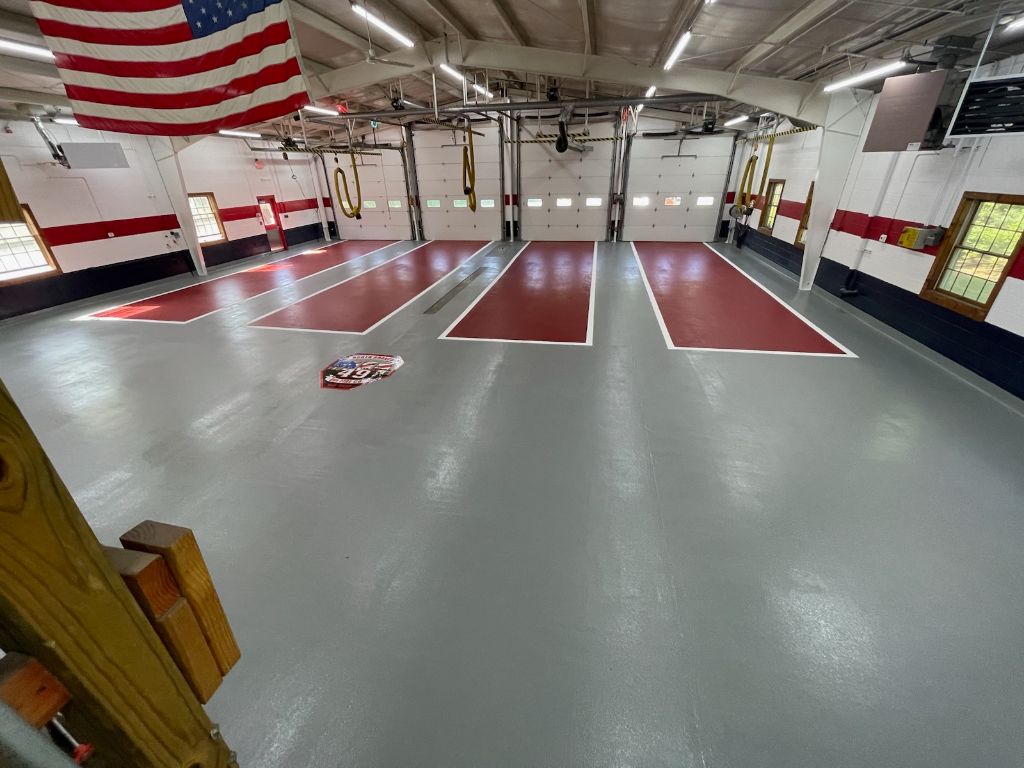 Fire station floor with pigmented urethane cement, lines and logo, Branchburg, NJ